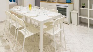 A compact kitchen with white cabinets, a stove, and a refrigerator. - White Blue Apartment at Sanit by Wonderful Italy (Naples)