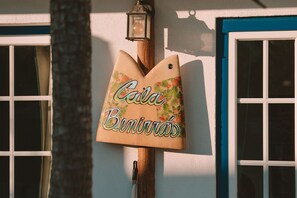 A wooden mailbox with the text "Casa Beníveras" on a building facade.