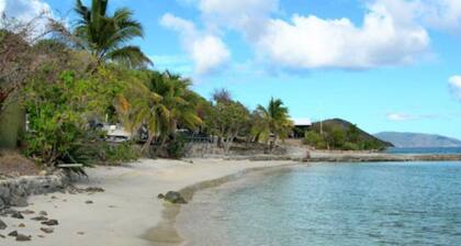 Luxury 3BR old world waterfront estate with a boat and SUV.