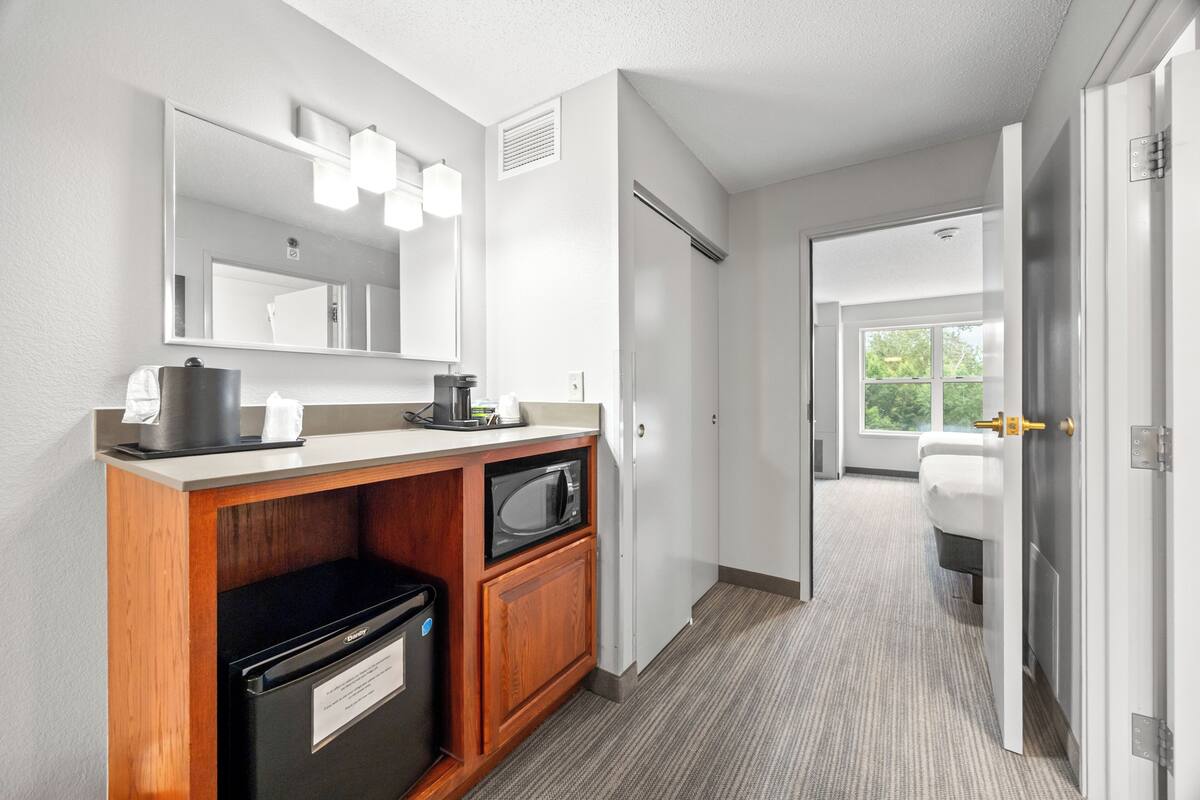 A modern bathroom with a sink, mirror, and toilet.