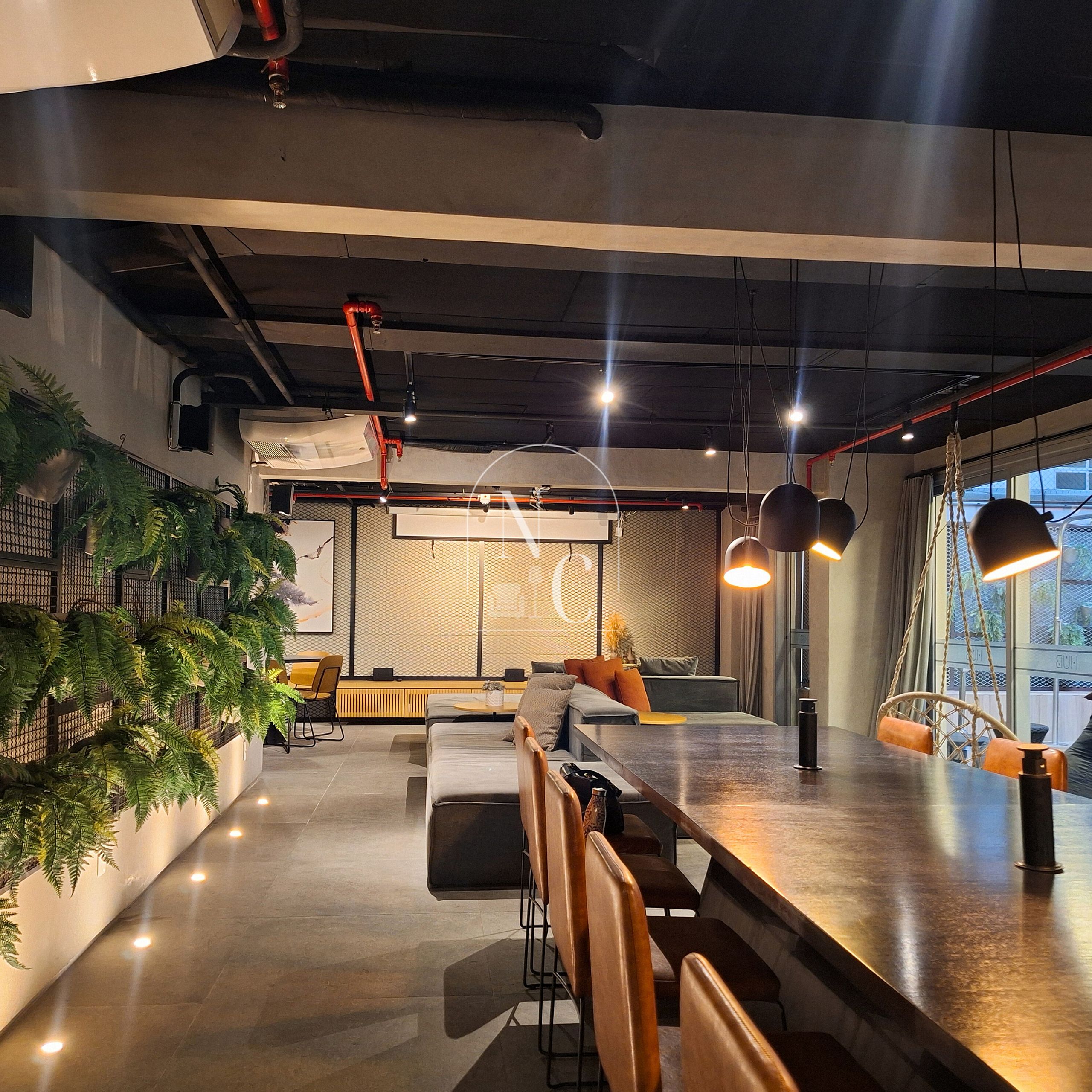 Un intérieur moderne avec un bar, des sièges et une vue sur l’extérieur grâce à une grande fenêtre.