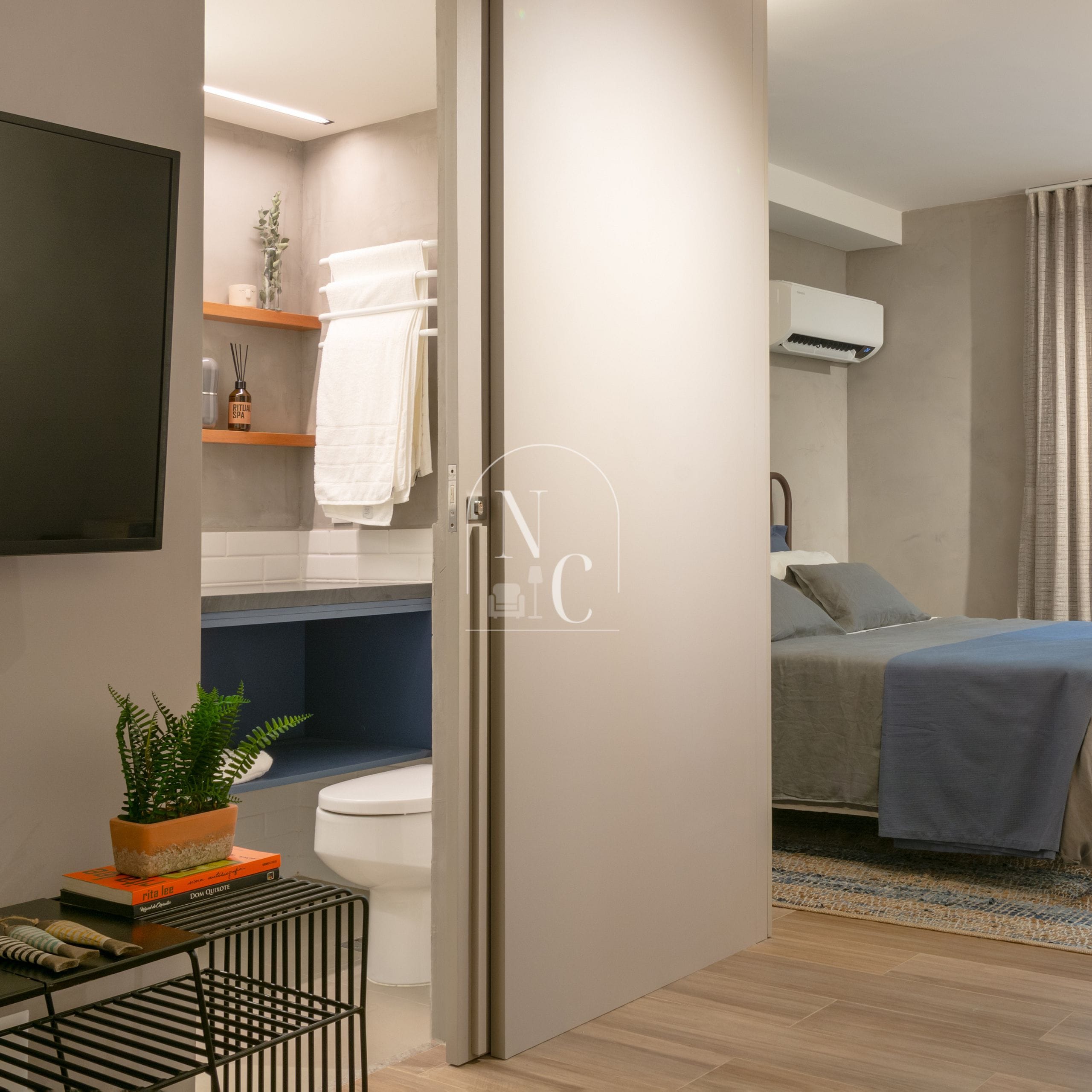 A modern bathroom with a toilet, sink, and towel rack.
