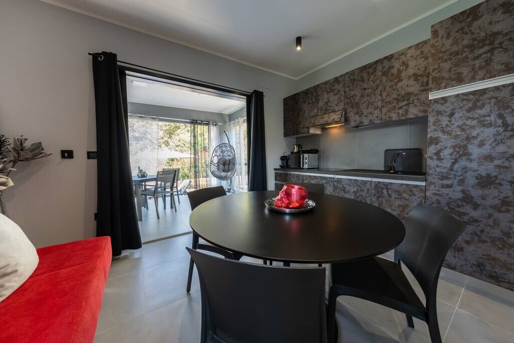 A modern kitchen with a dining area.