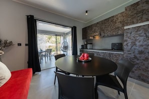 A modern kitchen with a dining area.