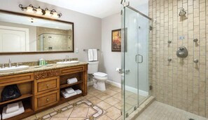 Bathroom features a double sink vanity with a large mirror, granite countertop, and wooden cabinetry.