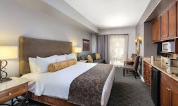 Relax in this inviting room with a large bed, desk, and TV.