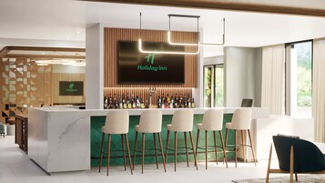 A bar area with a modern design, including a marble countertop, bar stools, and a variety of liquor bottles.