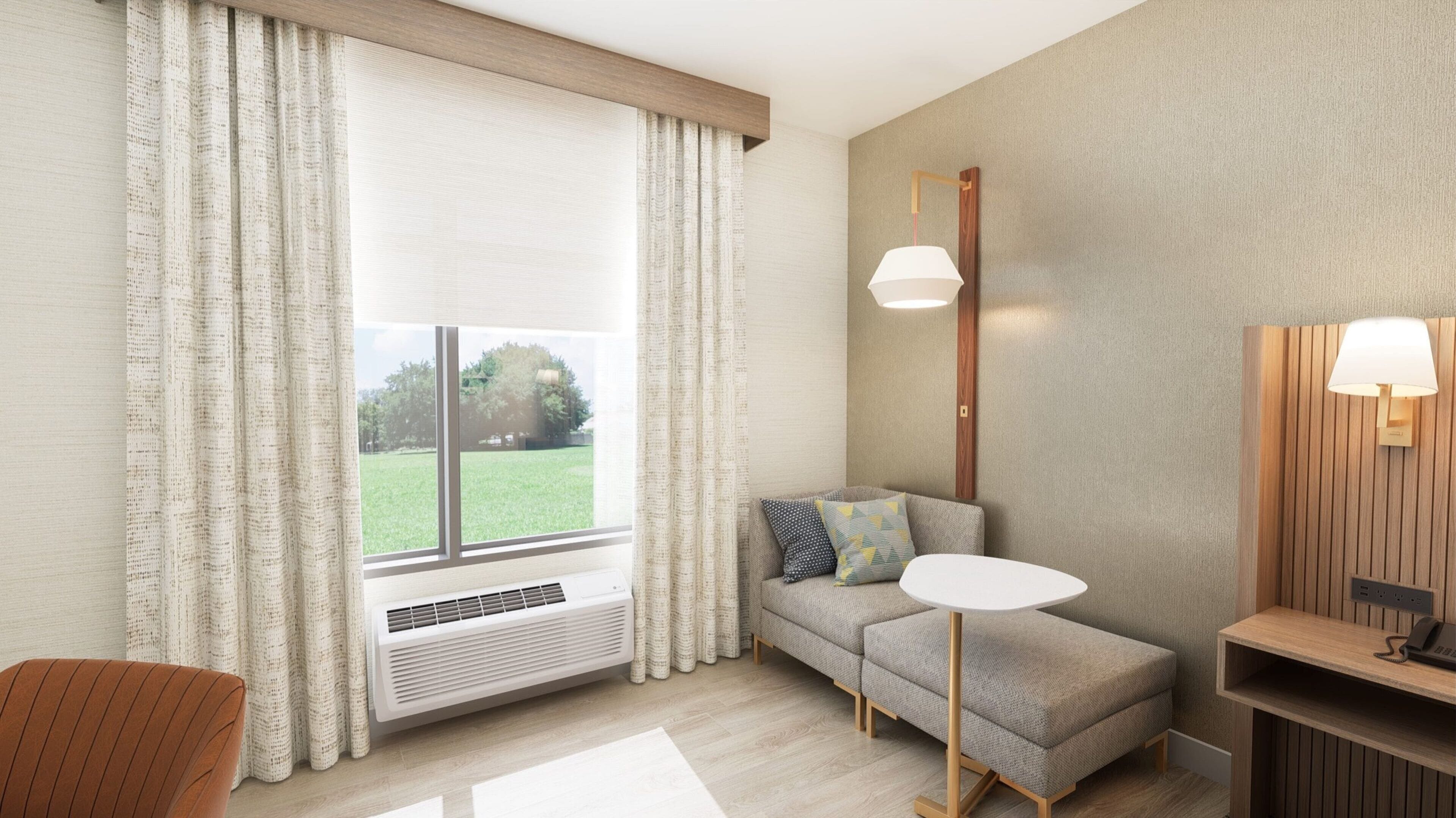 A modern living room with a sofa, a small table, a standing lamp, and a large window with curtains.