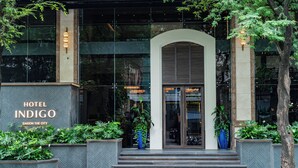 The entrance of Hotel Indigo with a modern facade, large windows, and a welcoming archway. - Hotel Indigo Saigon The City by IHG (Ho Chi Minh City)