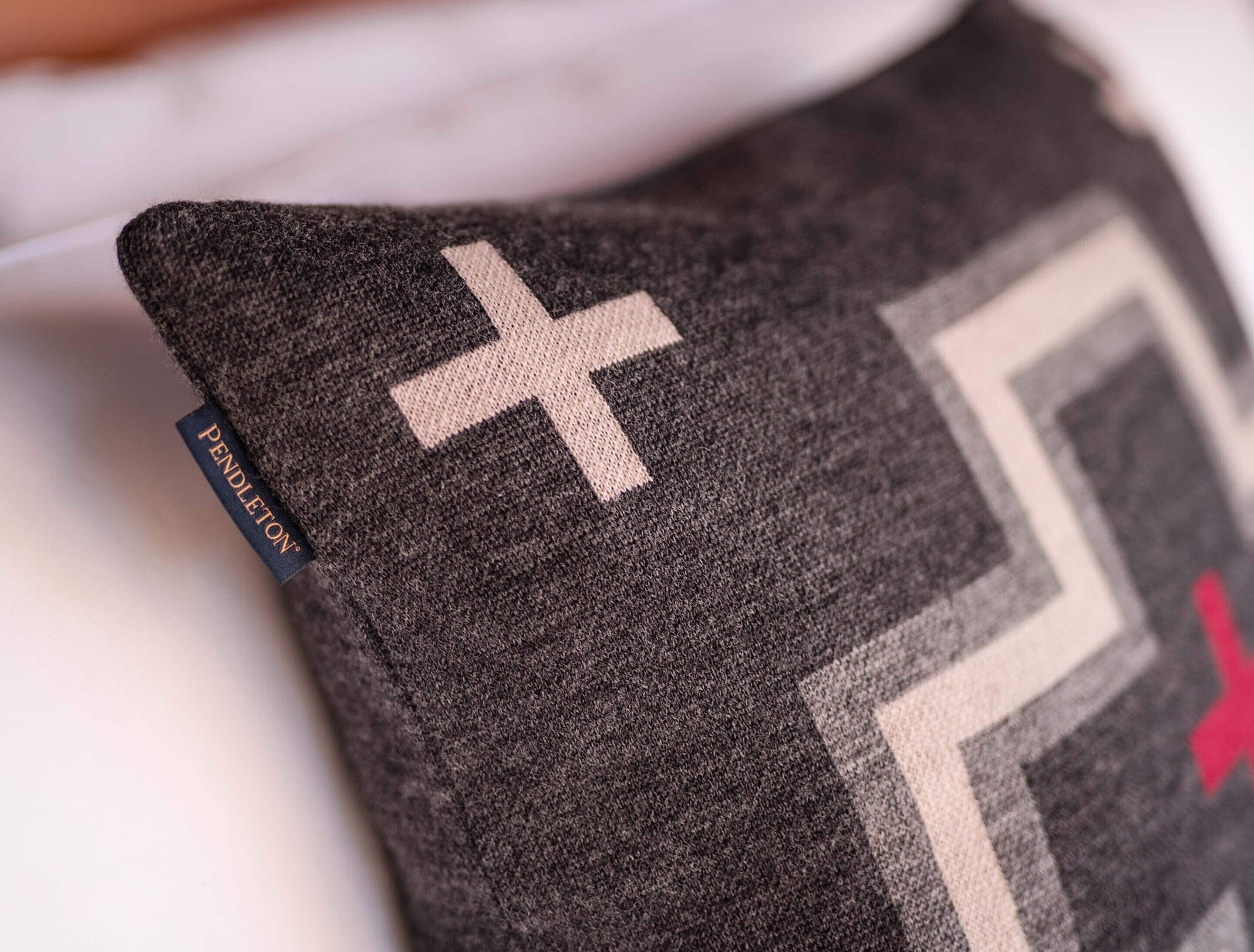 A close-up of a fabric with a geometric pattern and a visible brand label.