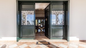 A hotel entrance with a doormat, a piano, and a chandelier visible inside. - Villa Petrone | Luxury Four Seasons-Jacuzzi&Pool (Emilia-Romagna)