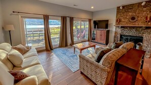 A spacious living room with a sofa set, a coffee table, and a fireplace.