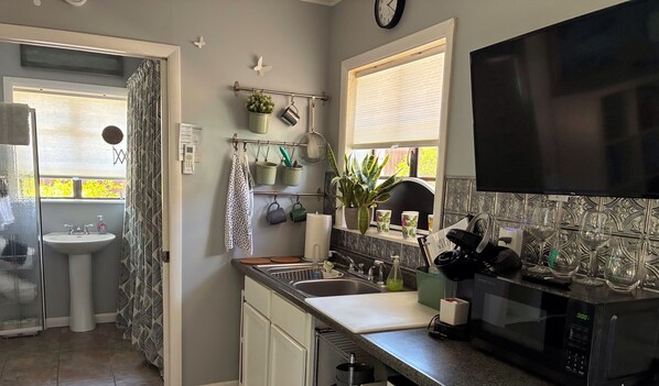 Fridge, microwave, coffee/tea maker, cookware/dishes/utensils