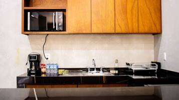 Fridge, microwave, coffee/tea maker, cookware/dishes/utensils