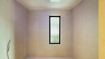 A small, enclosed shower area with a window, tiled walls, and a ceiling light.