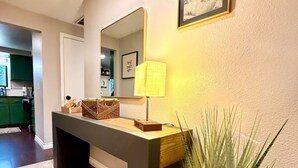 A modern bathroom with a vanity, mirror, and a potted plant. - Sleek Urban Retreat in Happy Valley (Happy Valley)
