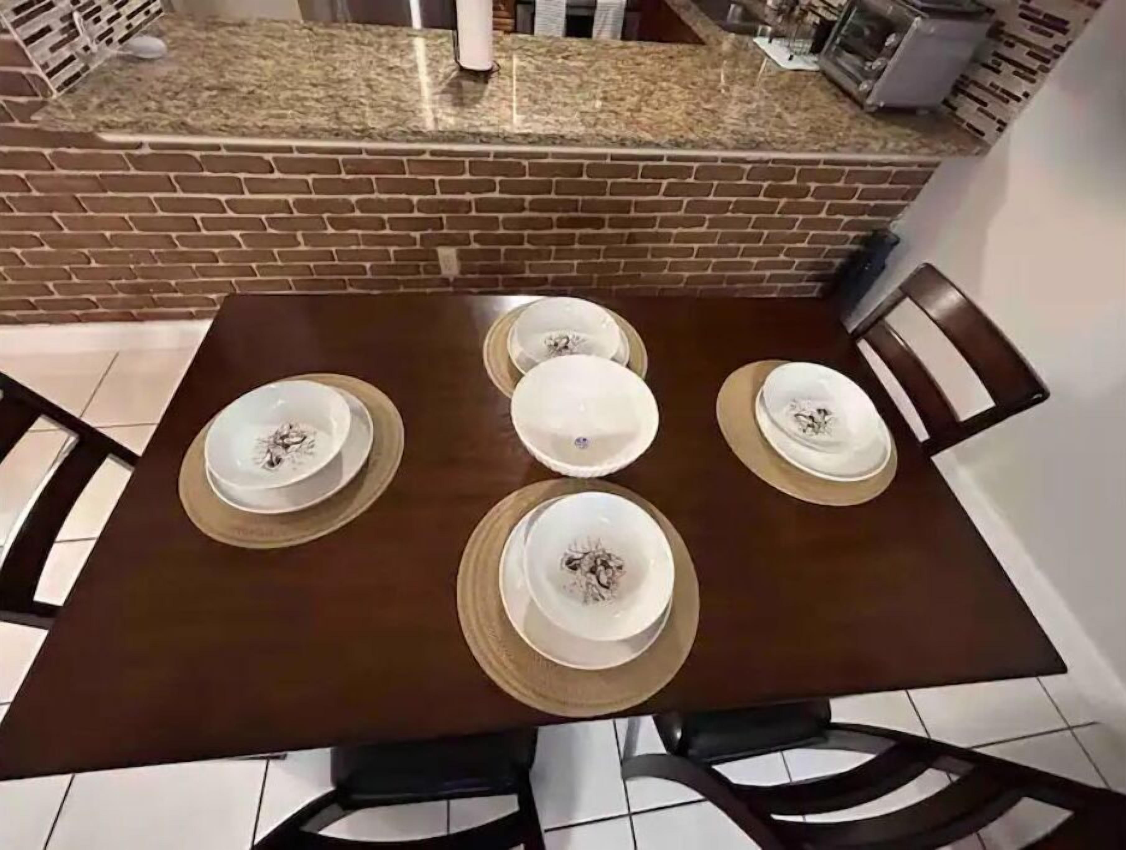 A dining table set with plates, bowls, and cutlery.