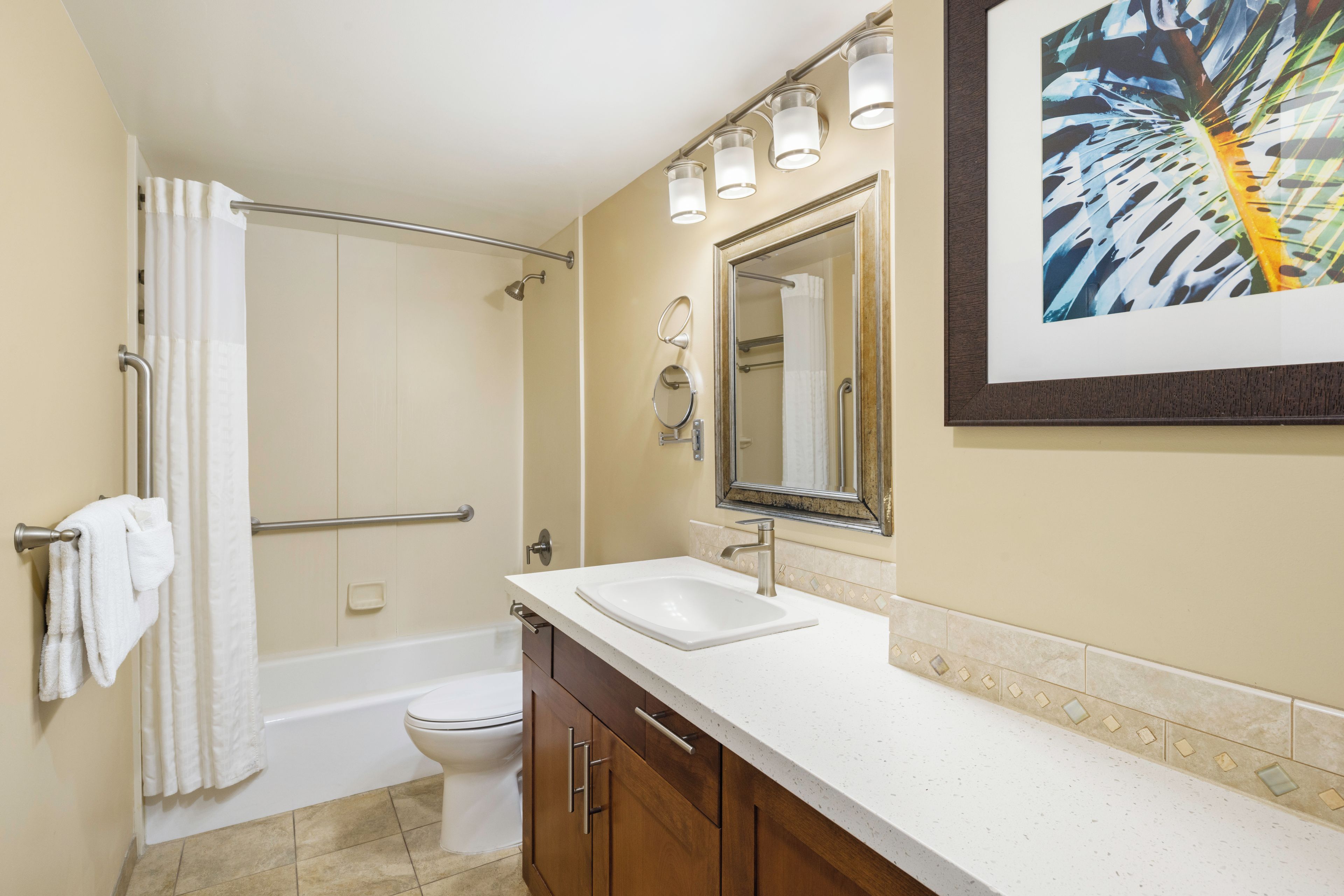 A bathroom with a bathtub, a toilet, a sink, and a shower.