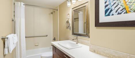 A bathroom with a bathtub, a toilet, a sink, and a shower.