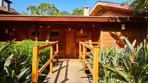 A wooden cabin with a wooden porch and a door marked with the number 30.