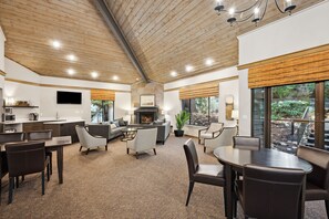A spacious living area with a fireplace, comfortable seating, and large windows offering a view of the outdoors. - NEW Lux Bellevue 2BD 2BA Condo - Free Parking (Bellevue)
