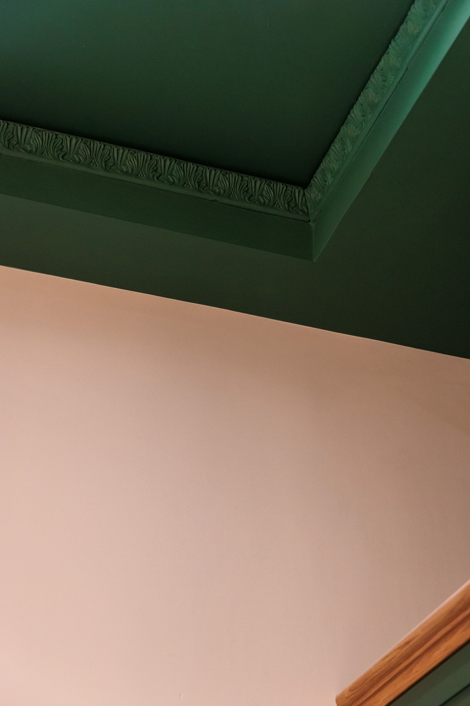 A room with a green ceiling and a plain wall.