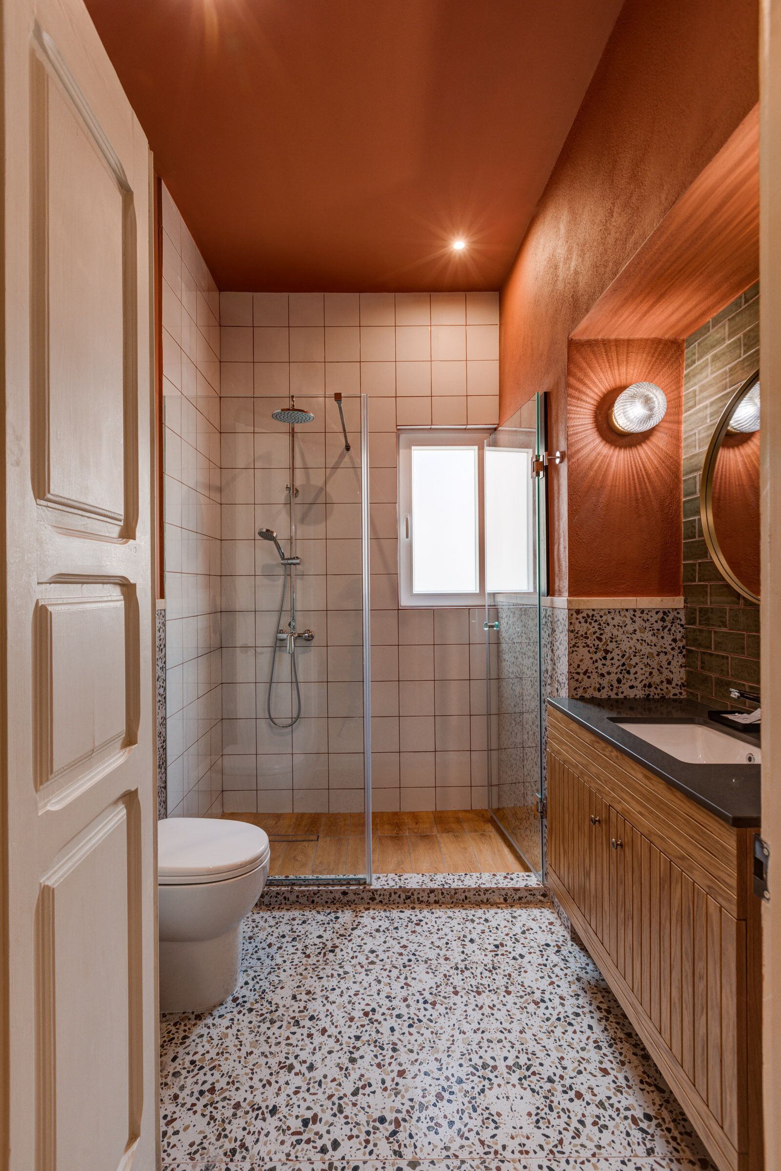 A bathroom with a shower, toilet, and vanity.