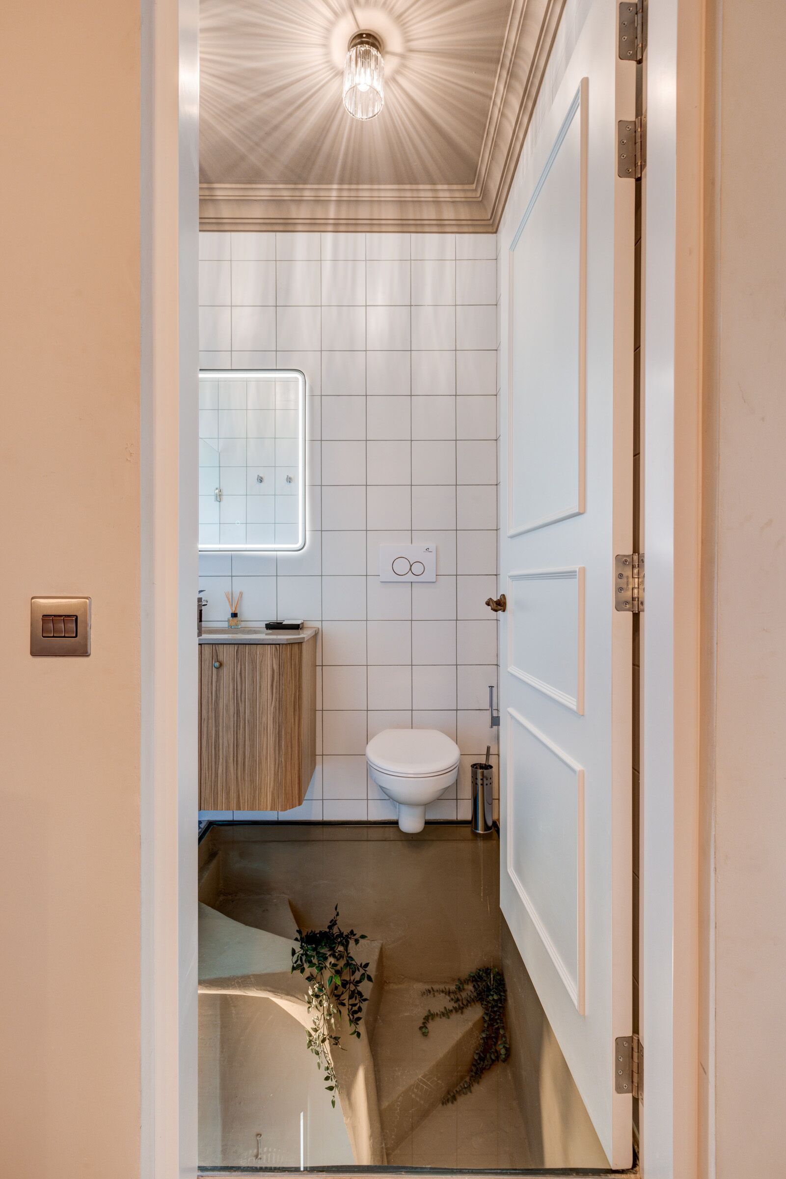 A compact bathroom with a toilet, sink, and vanity.