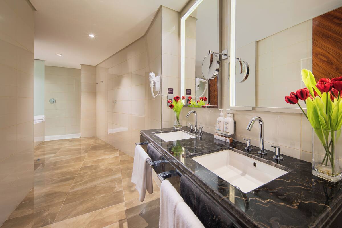 shower, hair dryer, slippers, towels