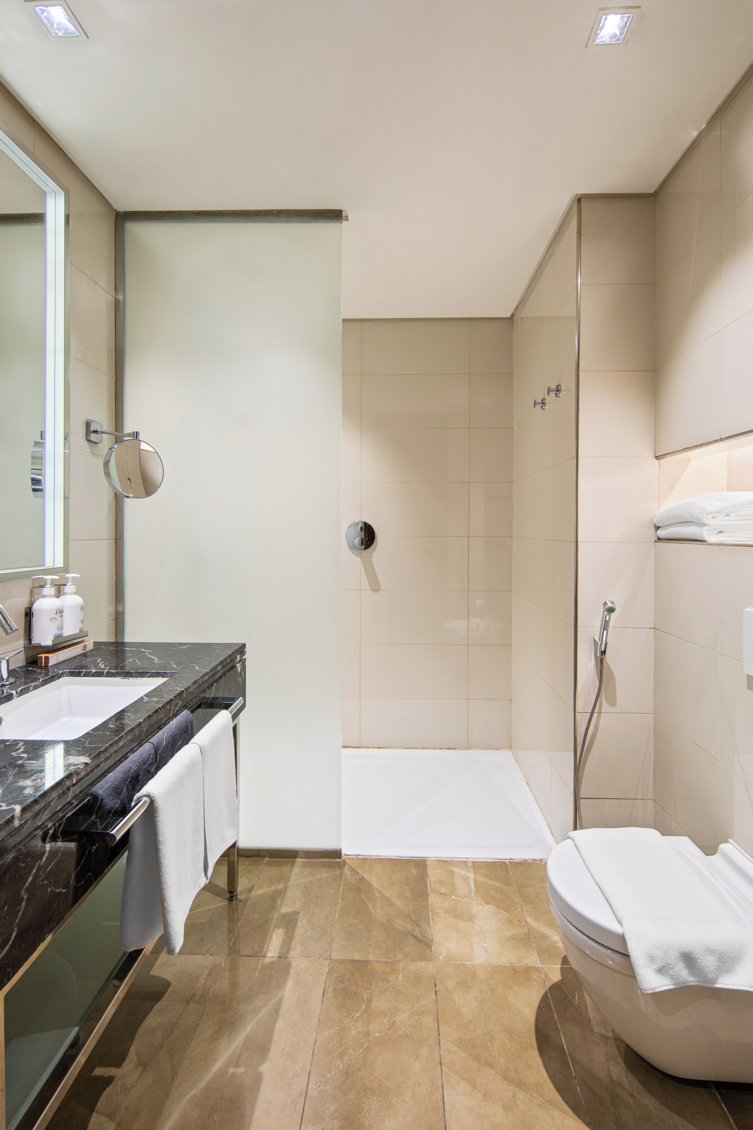 shower, hair dryer, slippers, towels