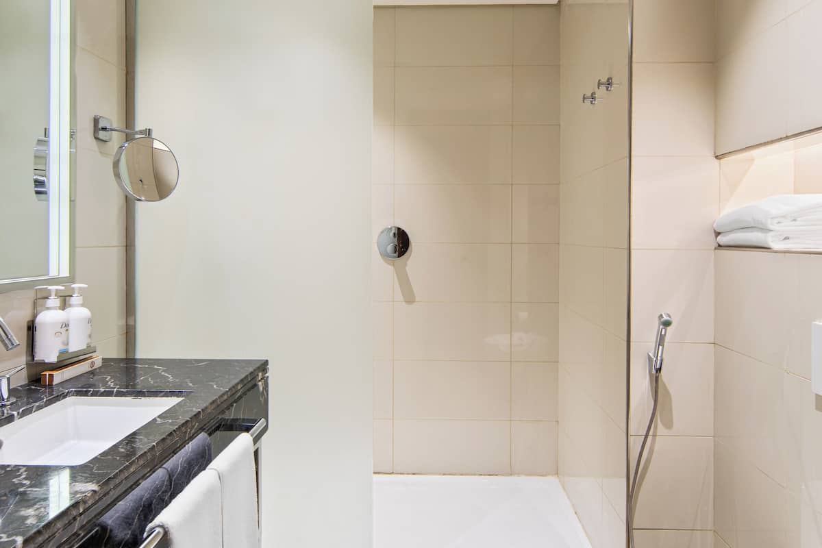 shower, hair dryer, slippers, towels