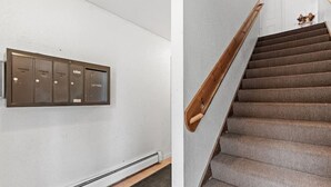A set of metal lockers and a carpeted staircase with wooden handrails. - Tranquil 2BR Apt Mpls - 8075 Apt 3 (Minneapolis)