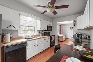 Coffee/tea maker, fridge, cookware/dishes/utensils