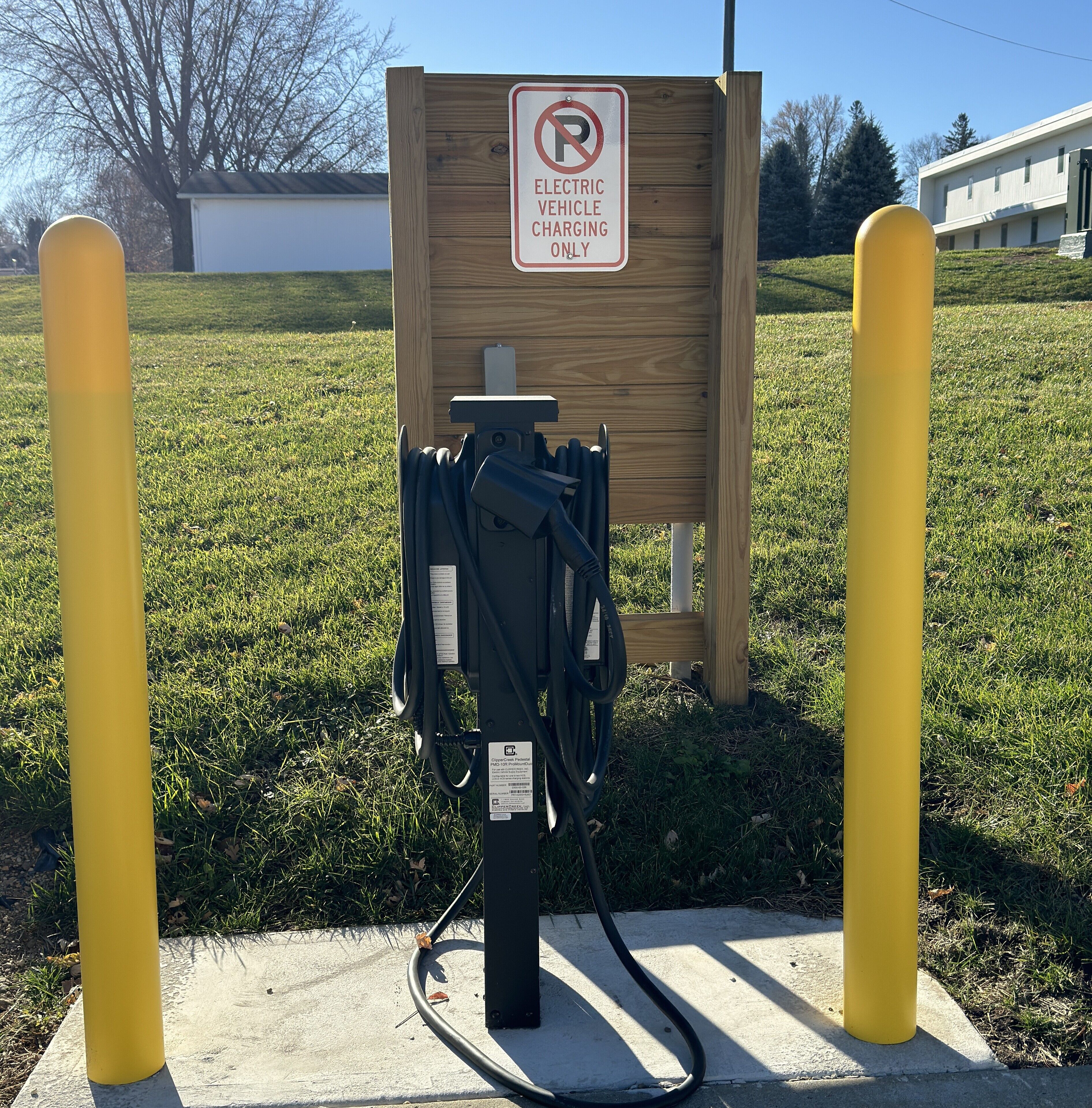 An electric vehicle charging station with a sign indicating it is for electric vehicle charging only.