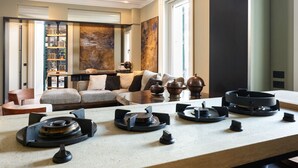 A modern living room with a fireplace, a sofa set, and a coffee table. - Mastroianni House with Terrace by Hostalia (Roma)