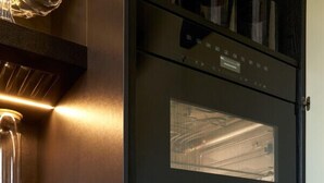 A kitchen with a built-in oven and a stainless steel sink. - Mastroianni House with Terrace by Hostalia (Roma)