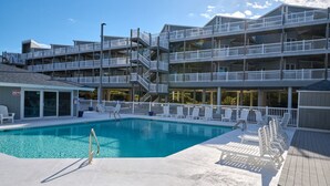 A multi-story hotel with a swimming pool, outdoor seating, and balconies. - MillionDollarView-Oceanfront 1BR-Updated! (Salter Path)