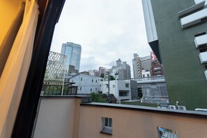 A cityscape with modern buildings, including a prominent skyscraper. - Satellite Hotel Roppongi (Tokyo)