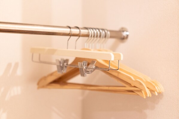 A metal rod with a wooden hanger attached to it.
