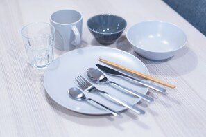 A neatly arranged table with a white plate, silverware, chopsticks, a glass, and two bowls. - Satellite Hotel Roppongi (Tokyo)