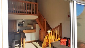 A two-story apartment with a kitchen, dining area, and a staircase. - Beautiful  flat with air conditioning, swimming pool and parking - 6REFC5 (SAINT CYPRIEN PLAGE)
