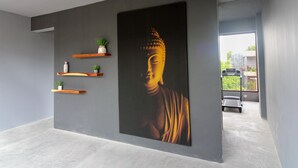 A modern interior with a large Buddha painting, wooden shelves with plants, and a treadmill in the background. - One-bedroom retreat with a private pool patio: your oasis in Tulum! (Tulum)