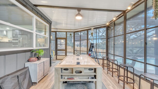 A modern kitchen with a large island, ample natural light, and a view of the outdoors. - Beautiful Lake getaway with pool, upgraded, pet friendly with lots of extras!! (Green Cove Springs)