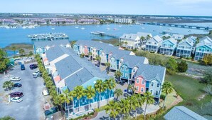 A coastal residential area with colorful houses, a marina, and a bridge in the background. - 20 Turtle Bay! 30 Night Minimum Stay - River View, Community Pool & Dock (Folly Beach)