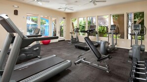 Una palestra con tapis roulant, ellittiche e panche per pesi.