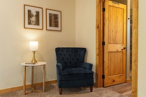 Relax in a cozy corner with a plush armchair, side table, and reading material.