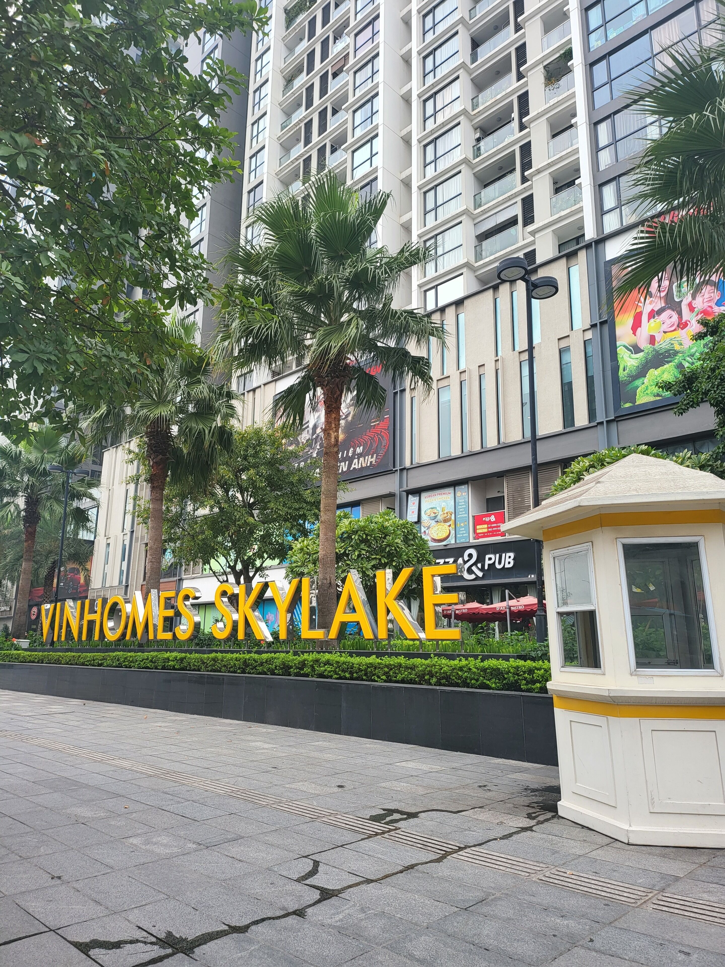 A modern building with a sign reading "VINHOMES SKYLAKE".
