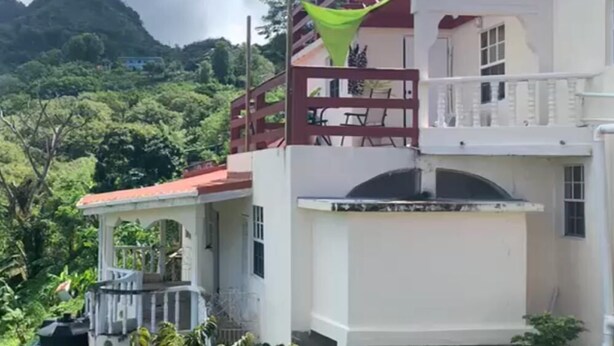 A multi-story building with a balcony and a green canopy. - Story Villa, 2 Bedrooms with Mountain & Ocean View (Canaries)