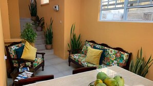 A living room with two sofas, a coffee table, and a staircase with potted plants. - Story Villa, 2 Bedrooms with Mountain & Ocean View (Canaries)