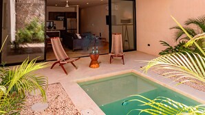 A modern two-story house with a balcony, a pool, and a dining area. - Spectacular House with private pool and garage (Mérida)